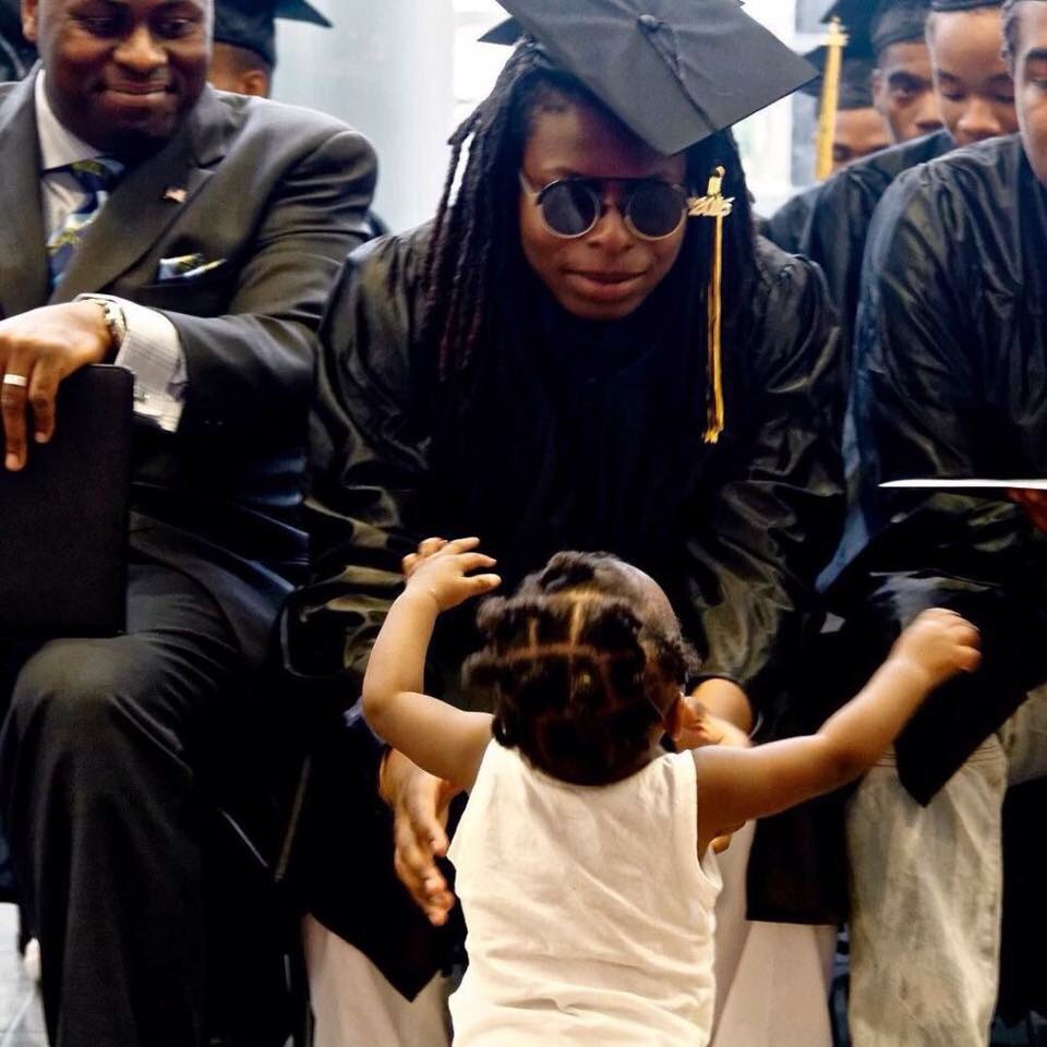 Graduating women hugs her daughter