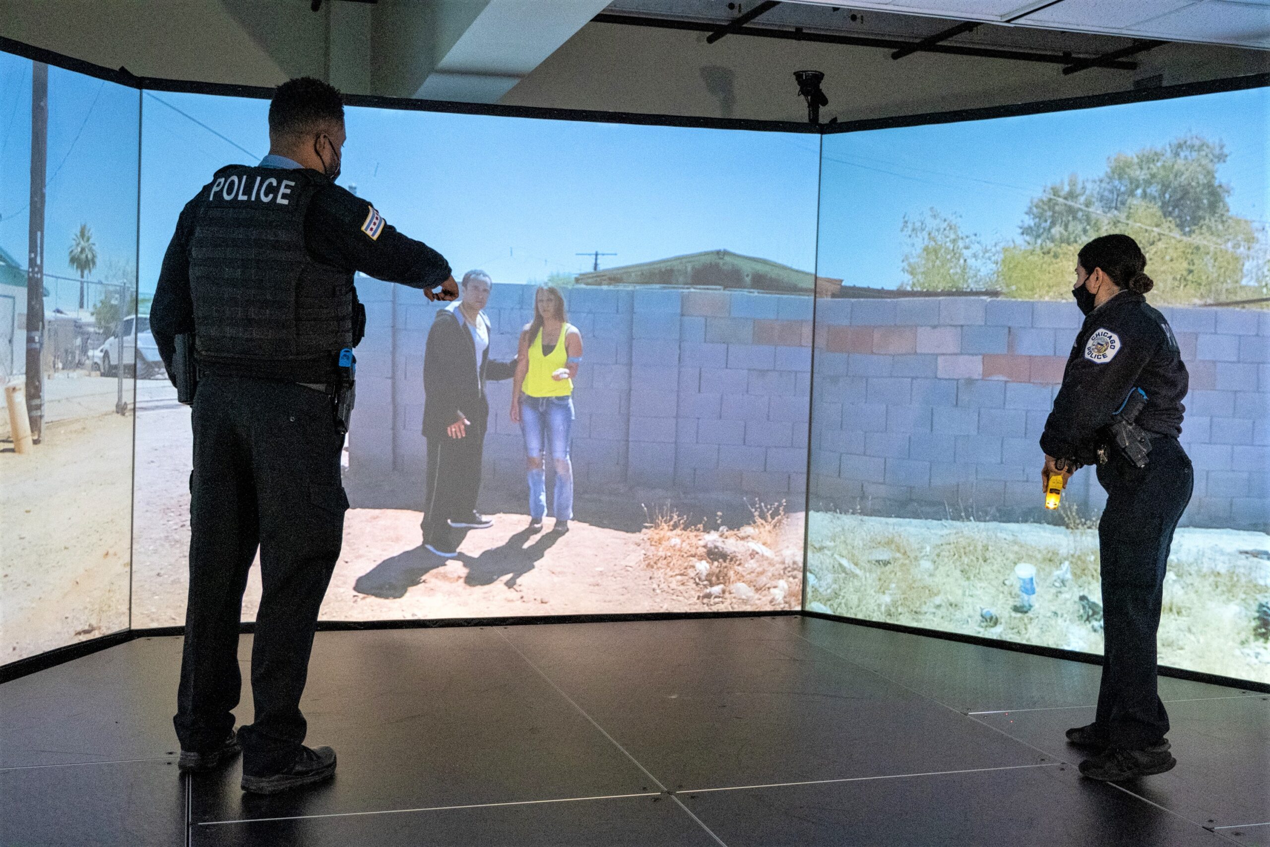 Police Officers training in front of a virtual simulator